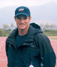 Cliff Meidl standing on track looking at camera