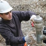Close up of man inspecting natural gas pipes