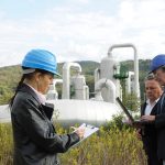Three engineers working near gas pipeline